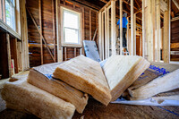 A person upgrades framing to prepare for installing insulation.