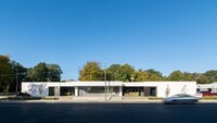 street view of single-story, modern white building